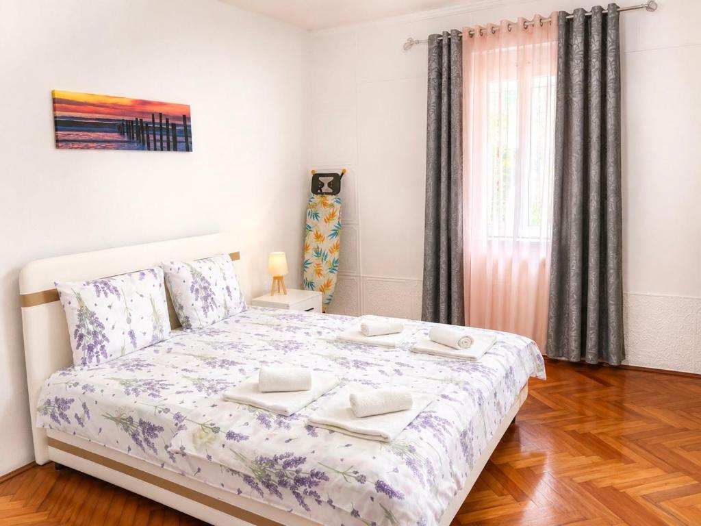 a bedroom with a bed with two towels on it at Apartman Stefan in Kotor