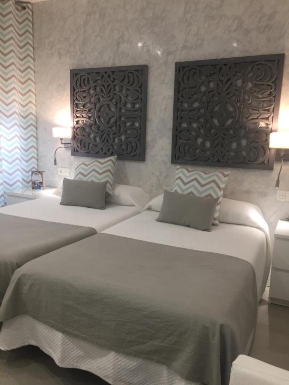 2 camas en una habitación de hotel con 2 lámparas en Hotel Felix, en Lorca