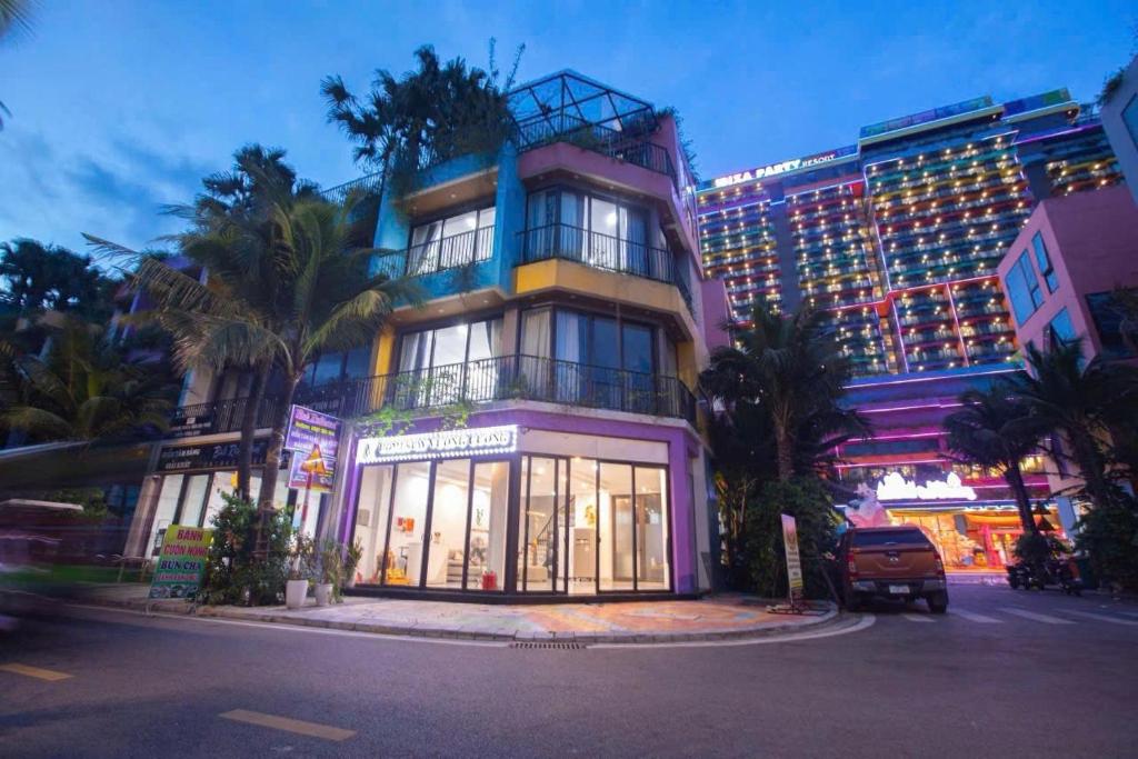 a building with palm trees in front of a building at Villa Flamingo C607 in Thanh Hóa
