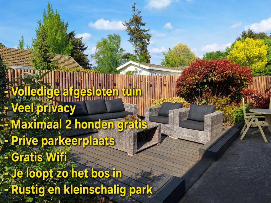 a patio with two couches and a wooden deck at Happy Place is een modern en comfortabel chalet met een grote afgesloten tuin op de Veluwe, Recreatiepark De oude Driest in Putten