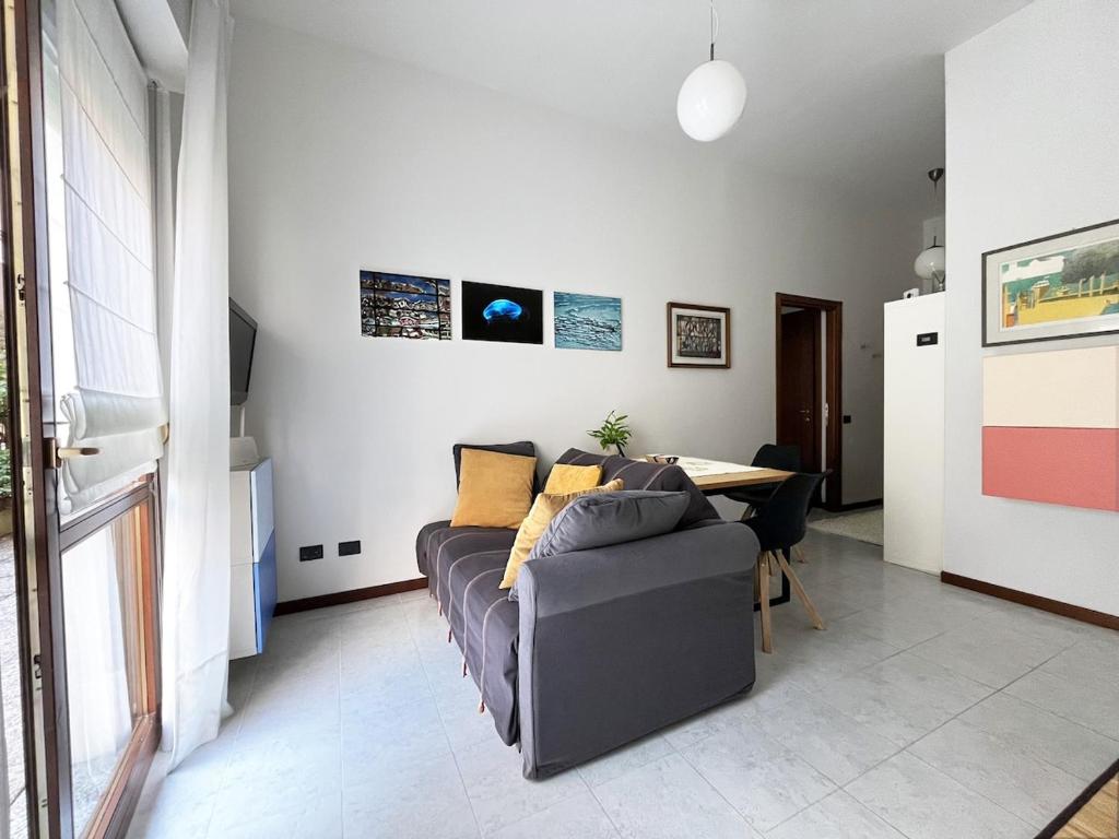 a living room with a couch and a table at The Water Lodge in Omegna