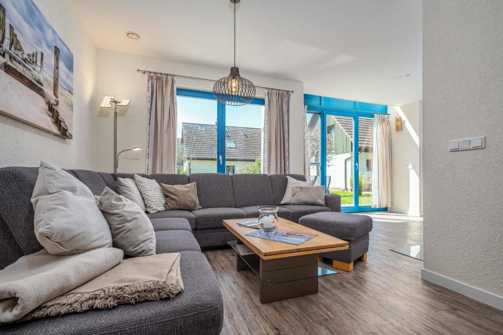a living room with a couch and a table at Meeresrauschen 1 in Groß Kirr