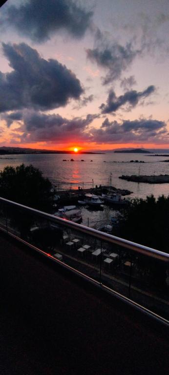 a sunset over a body of water with a bridge at stelisia2 in Chania
