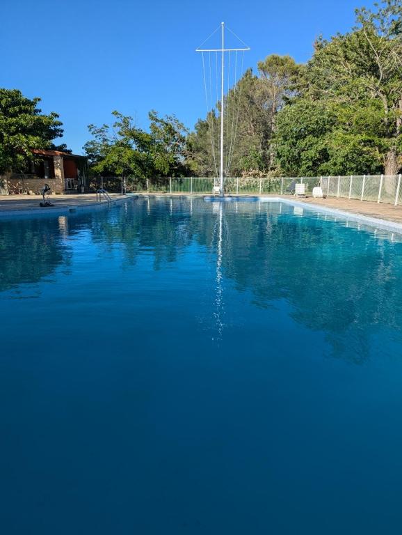 a large pool of blue water with a fountain at PHOENIX maison d'hôtes & SPA in Ginasservis