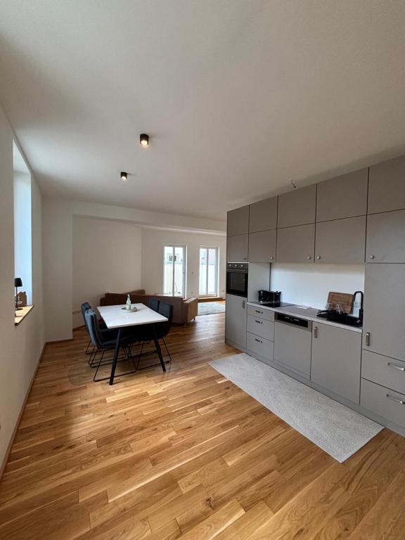 a kitchen with a table and a dining room at MainApartment 1A in Margetshöchheim