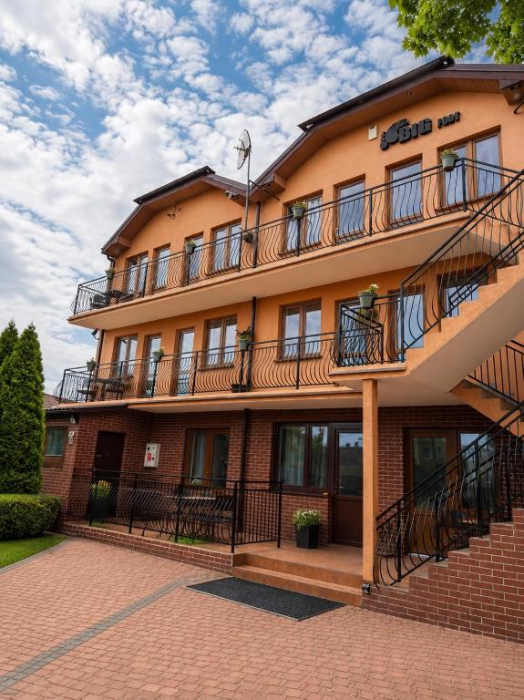 a building with balconies on the side of it at Big Foot by MANGO Food&Bar in Karwia