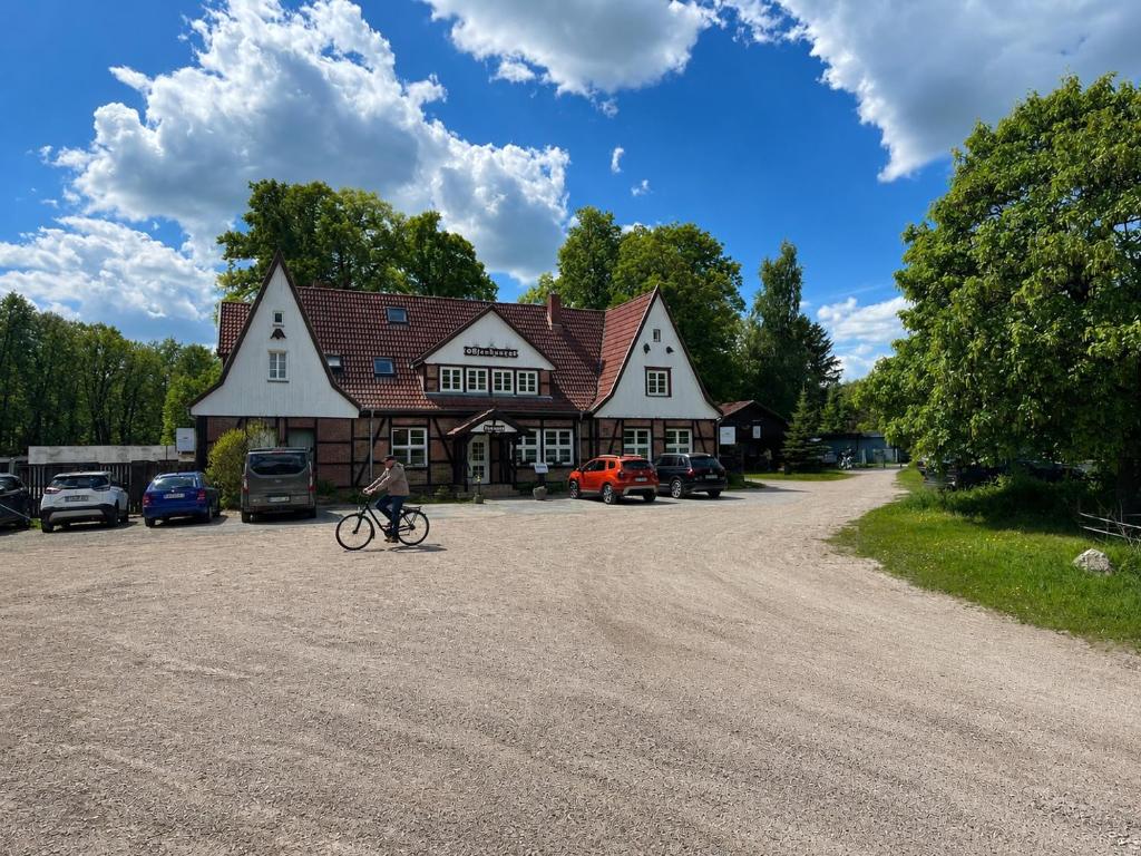 a person riding a bike in front of a building at Die Grenzburg in Güstrow