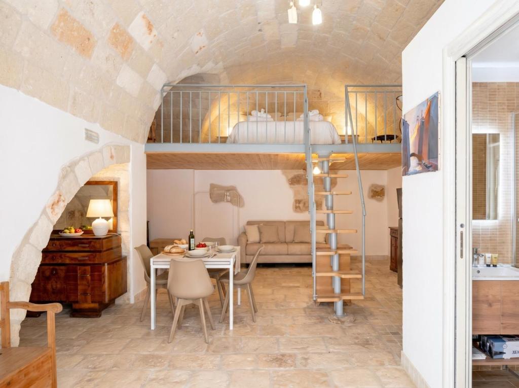 a room with a dining table and a bunk bed at Casa Tino - Retreat by the Sea and History in Polignano a Mare