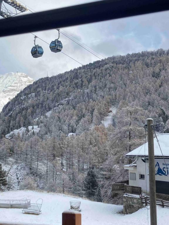 a view of a ski resort with a ski lift at Sole Mountain apartement in Zermatt