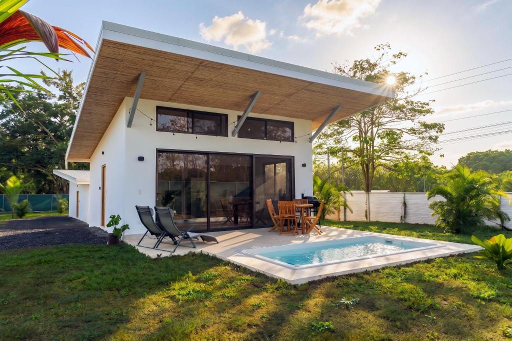 a house with a swimming pool in front of it at Villa Ticalma in Parrita