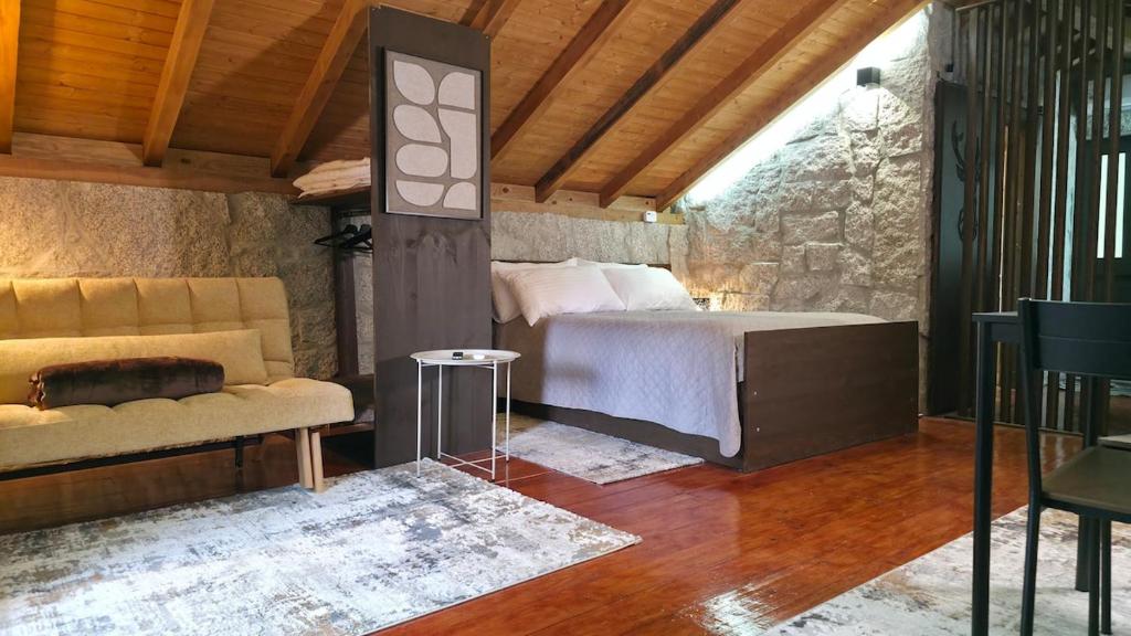 a bedroom with a bed and a couch in a room at Moose House EV Charging Pool Gated Community in Loivos