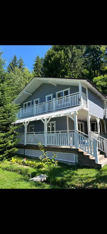 a large house with a large porch and white railing at Mountain apartments in Usteriki