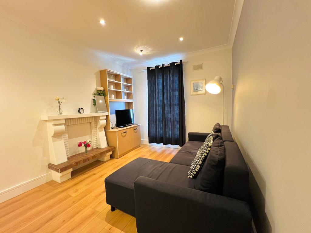 a living room with a couch and a fireplace at One Bedroom Central Site Apartment in Dublin