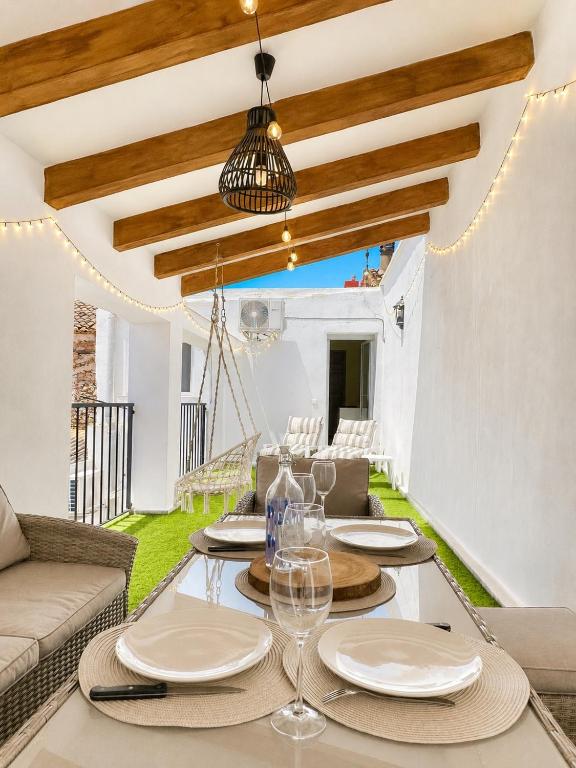 a dining room with a table and a couch at Casa Vicen in Bolbaite