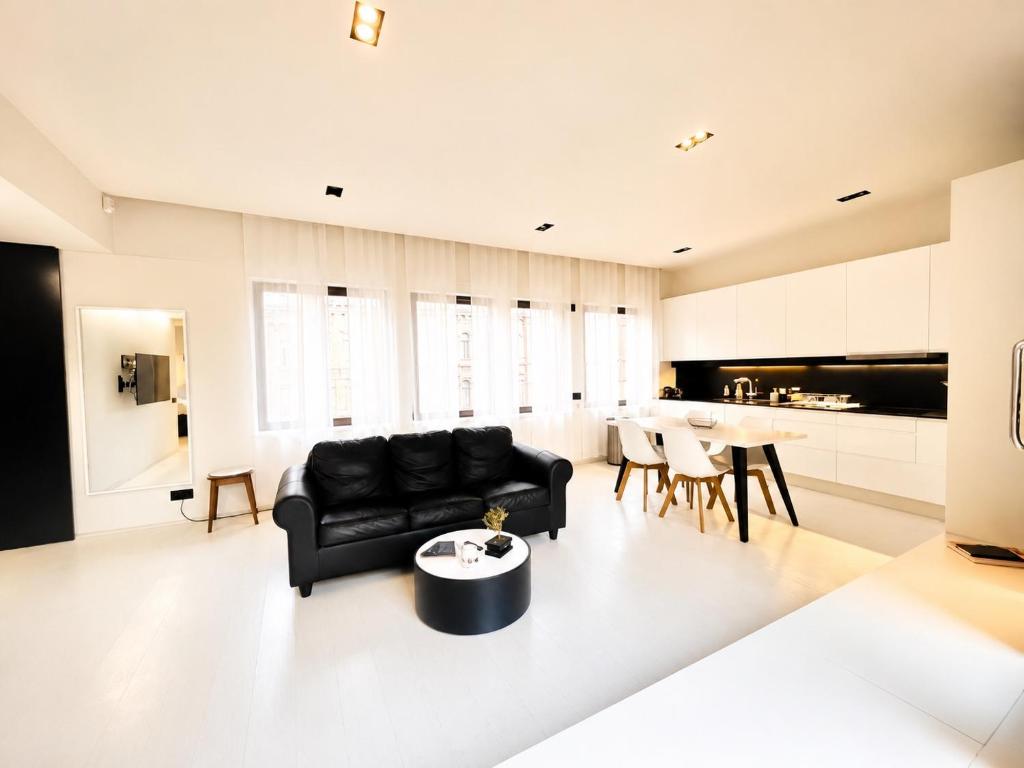 a living room with a black couch and a table at Elegant Central Apartment Quiet and Bright in Brussels