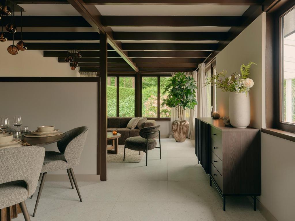 a living room with a table and chairs at Yasu Stay Sonnevijver Rekem in Lanaken