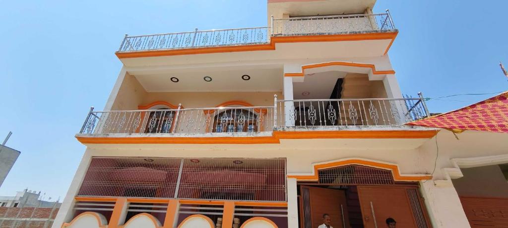 a building with two balconies on top of it at Hotel O HOME Swagat Homestay in Ayodhya
