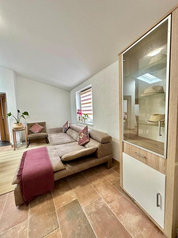 a living room with a couch and a window at Modern apartment with space for 6 in Weißenfels