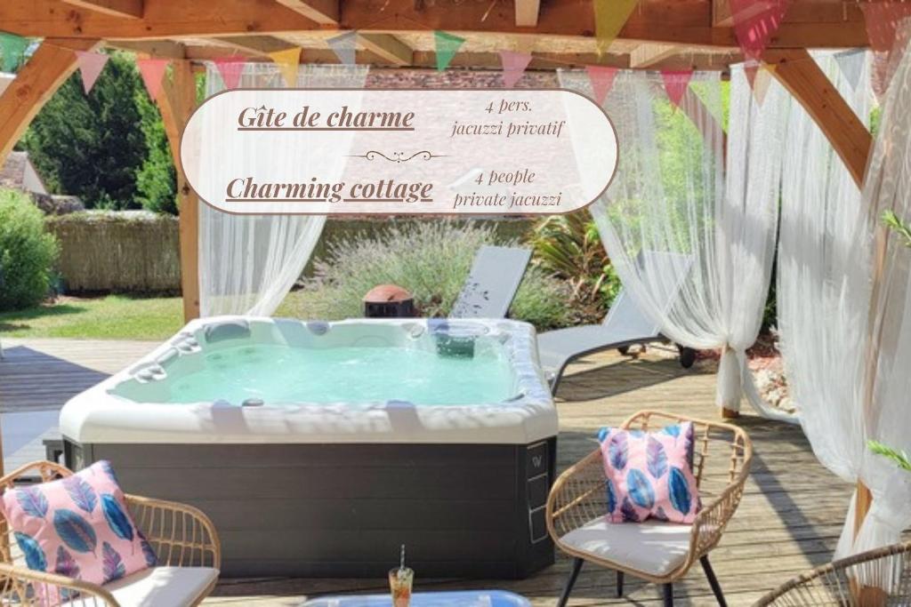 a hot tub in a gazebo with a sign at Gîte de charme Beaujoyeulx in Molineuf