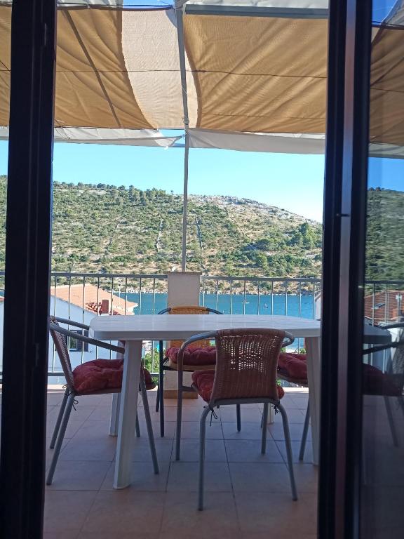 a table and chairs with a view of the ocean at LadyBird and Turtle in Podglavica