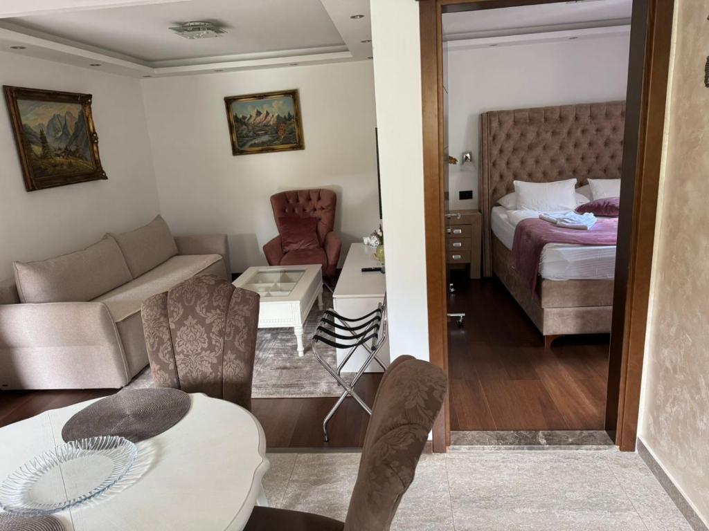 a small living room with a bed and a couch at I&G APARTMENTS in Kotor