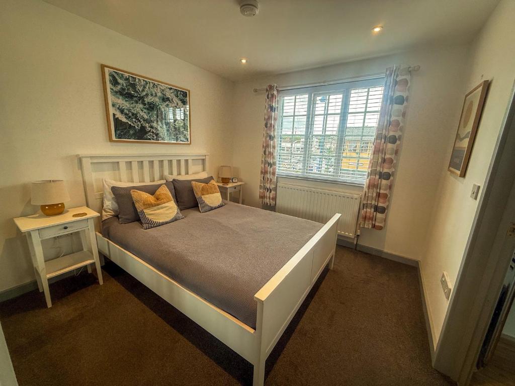 a bedroom with a bed and a window at The Crows Nest - Sheringham in Sheringham