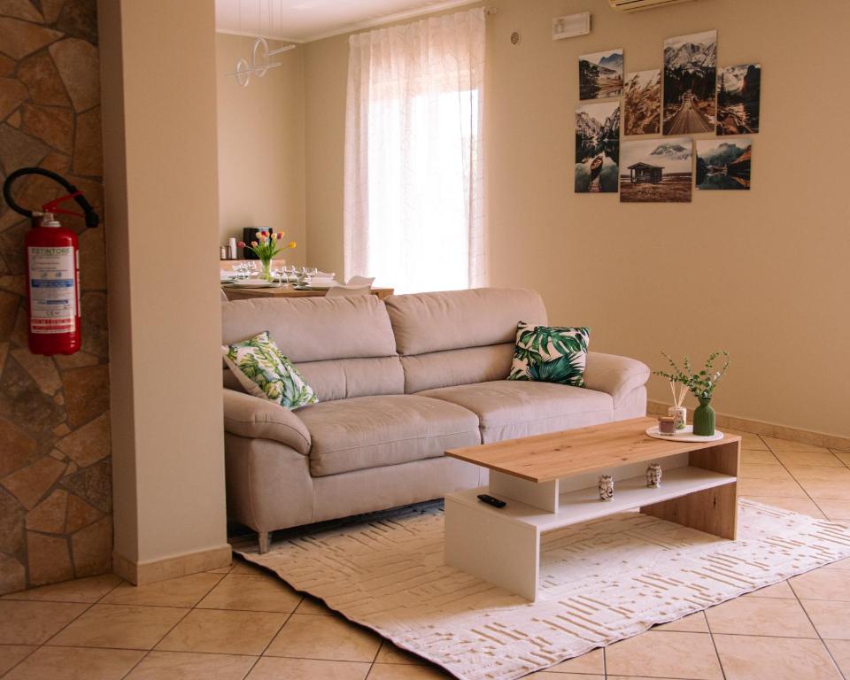 a living room with a couch and a coffee table at Tra Onde e Vette in San Leonardello