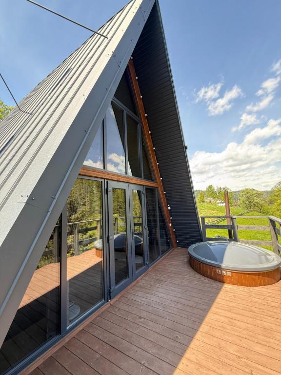 a view of a house with a hot tub on the deck at Лісовий Трикутник in Mykulychyn