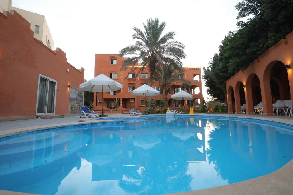 a large swimming pool next to a building at Settle inn Fajr Boutique hotel in Cairo