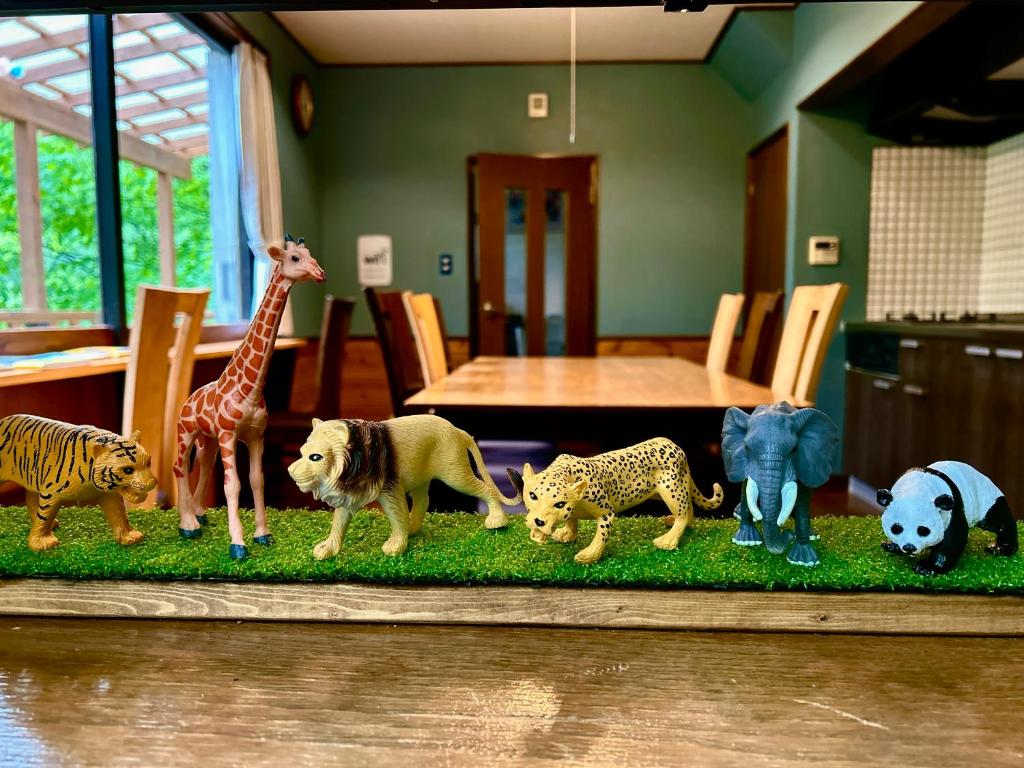 a group of toy animals on a table at チェックアウトは11時コテージそら豆ん家 in Nasu