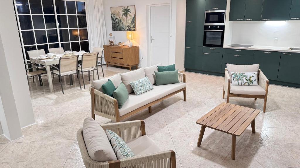 a living room with a couch and chairs and a table at Villa Nueva Martinique in Gros-Morne
