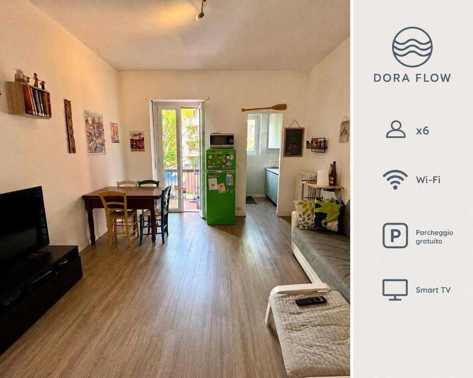 a living room with a table and a green refrigerator at Dora Flow in Banchette