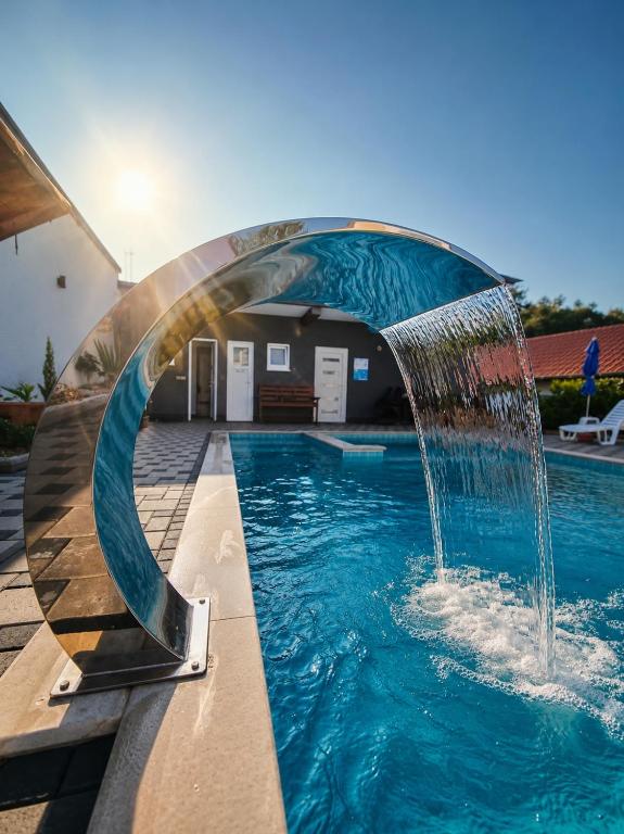 a pool with a water fountain in the middle at Holiday Home with Private Pool in Blagaj