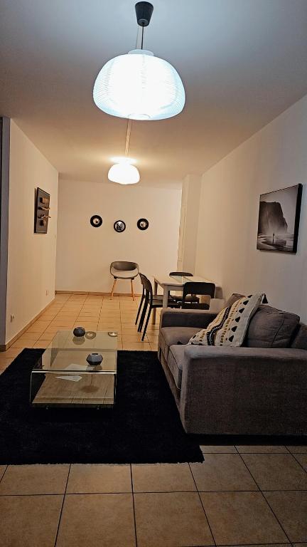 a living room with a couch and a table at L'Interlude in Saint-Denis