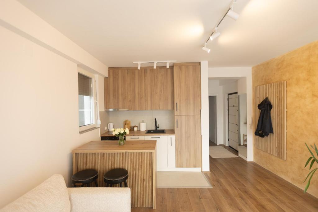 a kitchen and living room with a couch and a counter at Bitola Stay in Bitola