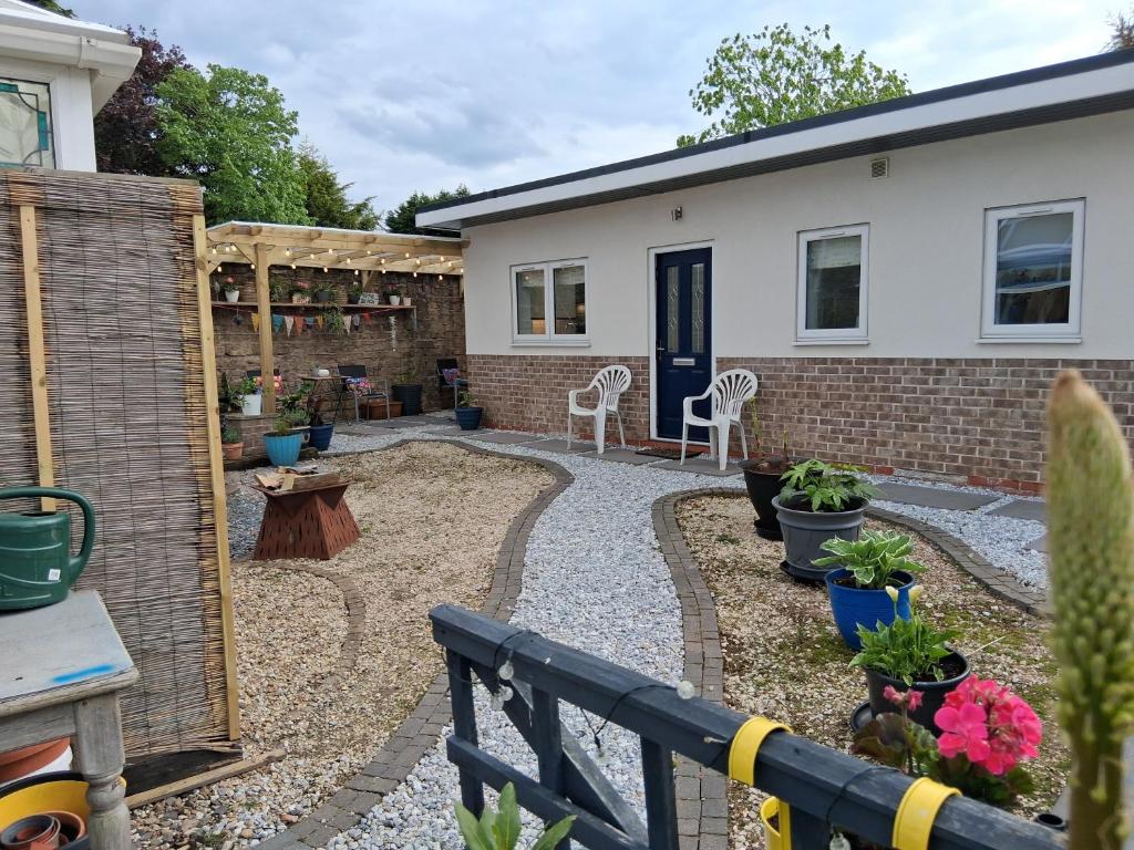 a garden with a patio and a house at Secret Bungalow in Warsop