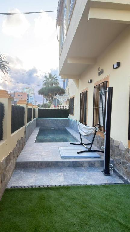 a chair sitting on the patio of a house at El Chalecito De Alicante in El Campello
