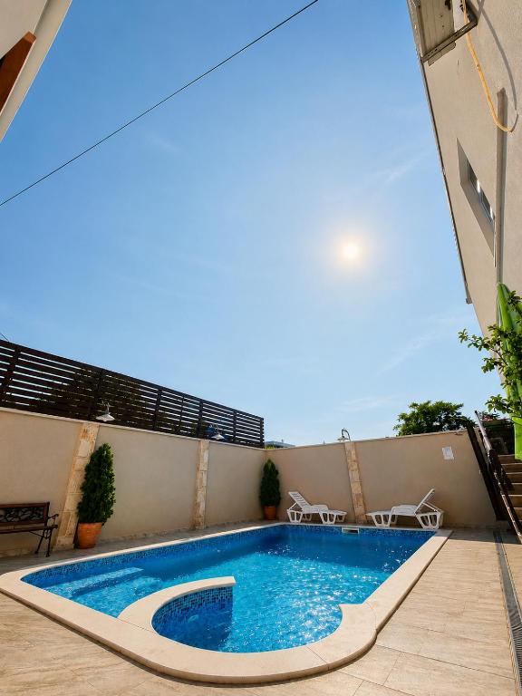 a swimming pool on the side of a building at Pansion & Apartments MOST Blagaj in Blagaj