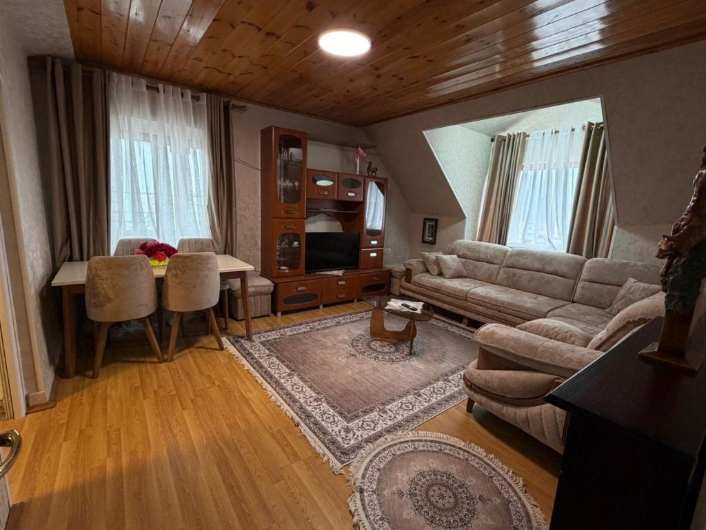 a living room with a couch and a table at Le Toit du Ciel in Pukë