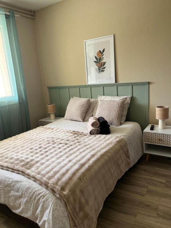 a teddy bear sitting on top of a bed at Mini studio privatif in Privas