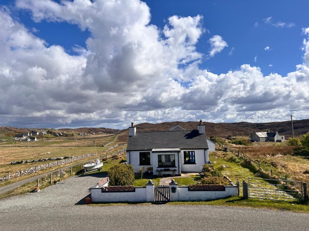 a house on the side of a road at Taigh Tuaram in Carloway