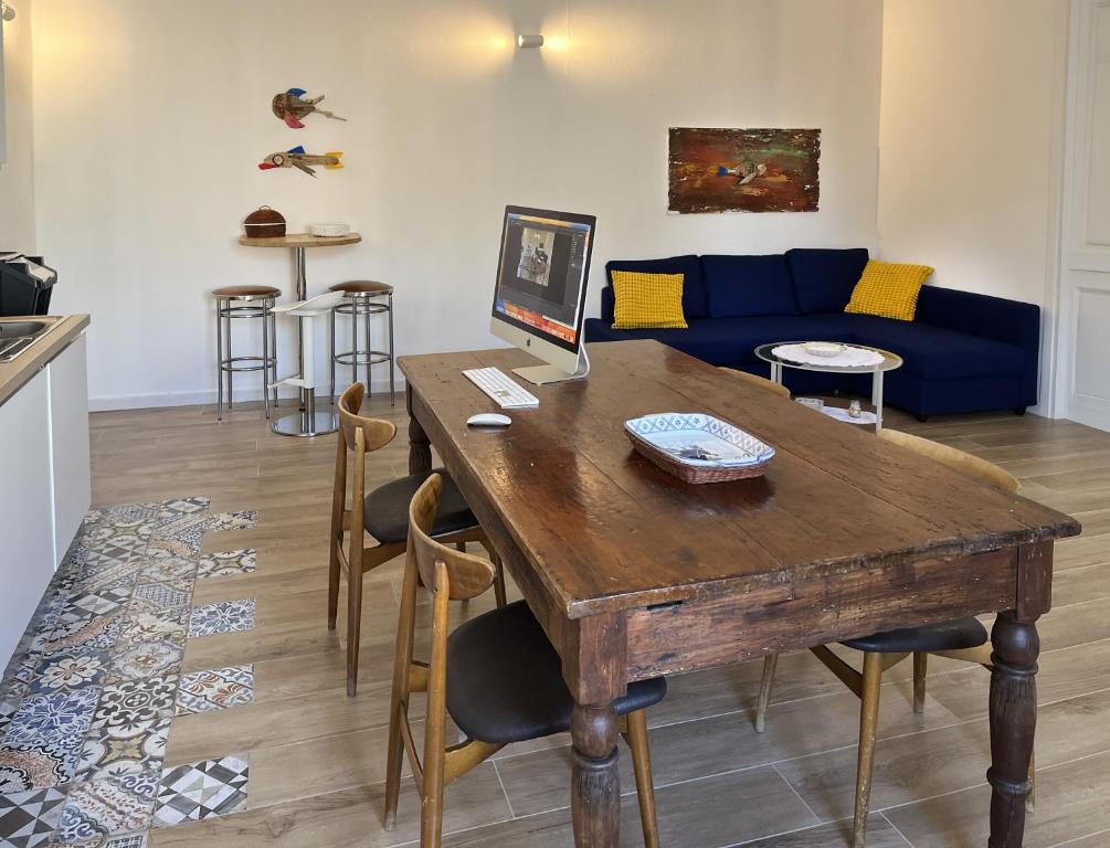 a living room with a wooden table and a blue couch at Antoni House in Bulzi