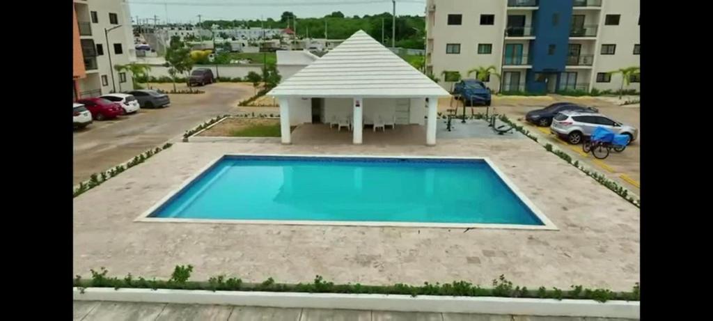 a swimming pool in a parking lot with a gazebo at Apartment With Swimming Pool close to Beach in La Romana