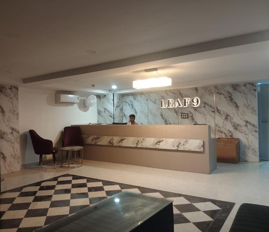 a lobby of a law firm with a man standing behind a counter at Leaf 9 Imperial, Subhash Nagar, Pacific Mall in New Delhi