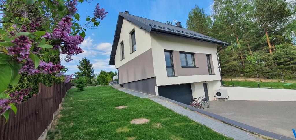 a house with a bike parked in front of it at Dom nad Szelmentem in Przejma Wysoka