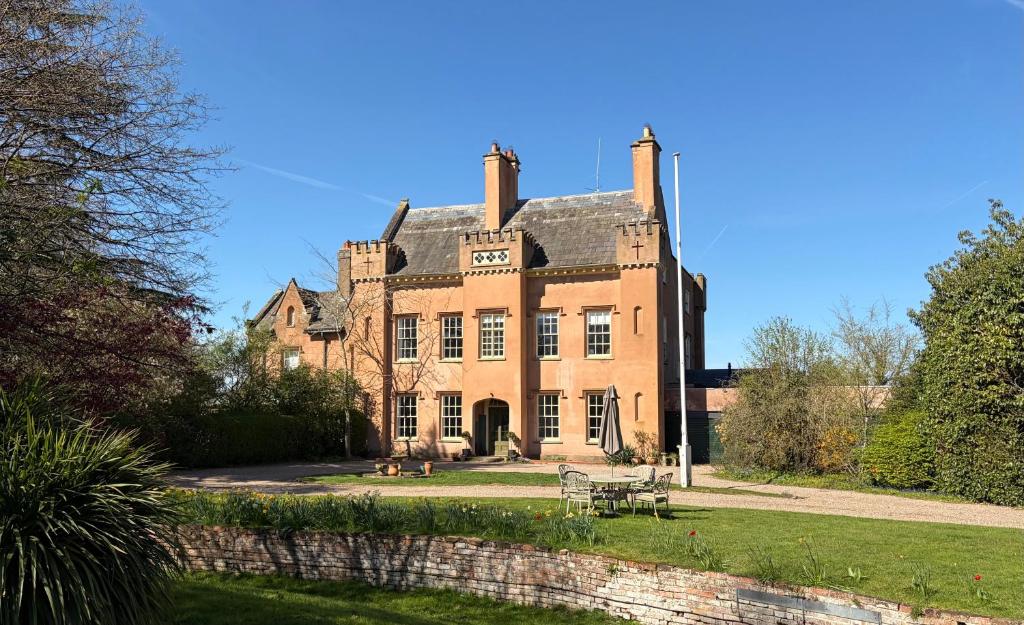 a large brick building with two chimneys on top at Bleasby Hall - Kelham Suite B&B in Bleasby
