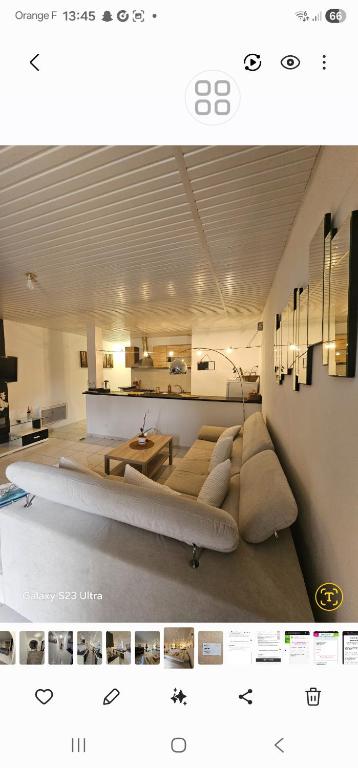 a picture of a living room with a couch at Sophie Appartement in Villeneuve-sur-Lot