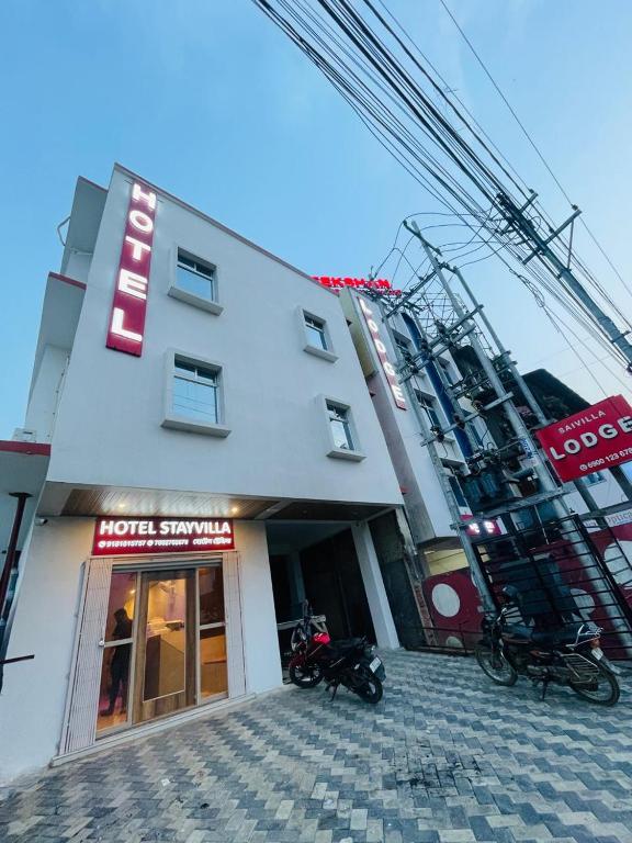 a building with motorcycles parked in front of it at Hotel STAYVILLA in Guwahati
