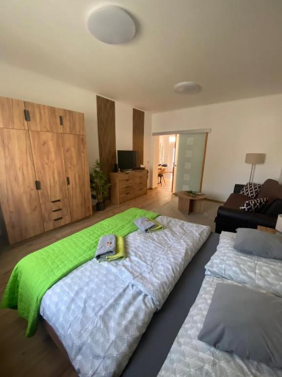 a bedroom with two beds with towels on them at Andalics apartment in Kaposvár