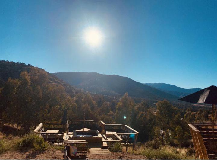 a view of a mountain with the sun in the sky at Casa Luna in Maitencillo